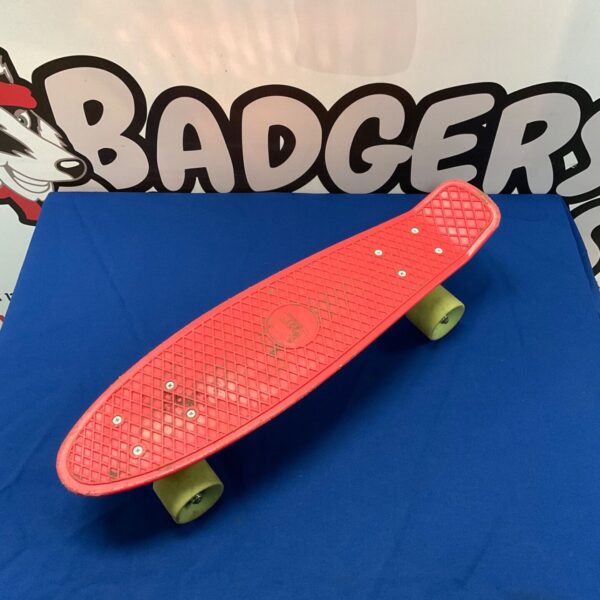 Red pennyboard skateboard for urban cruising and skateboarding.