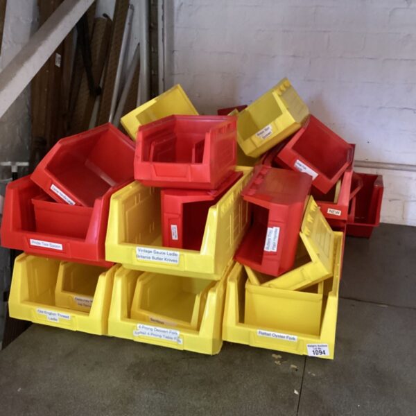 Stack of red plastic storage boxes for household organisation.
