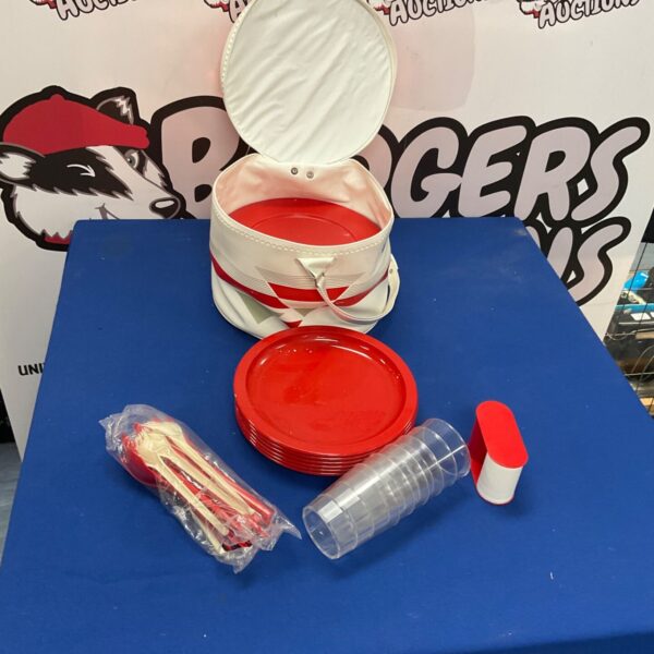 Red and white vintage style picnic set with basket and tableware.
