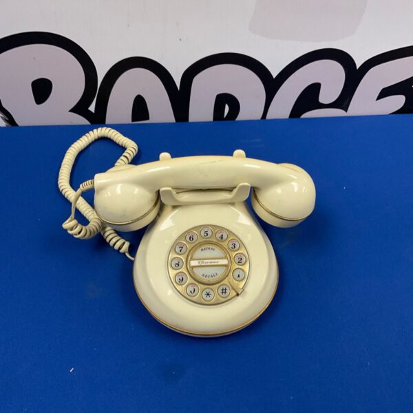 Cream coloured retro rotary dial telephone, vintage style.