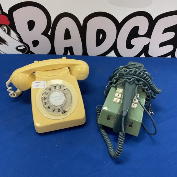 Vintage retro telephone with green trim, wall mounted design.