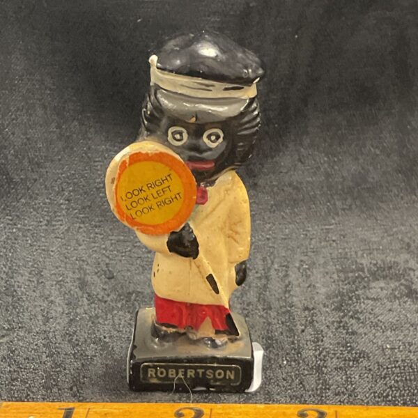 Vintage Robertson Golly figure at a road crossing.