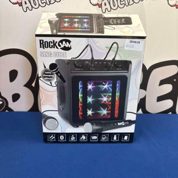 Boxed RockJam Singcube karaoke machine with microphone and controls.