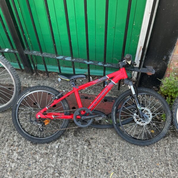 Red Rockrider ST900 Sport Trail Bike for outdoor adventures.
