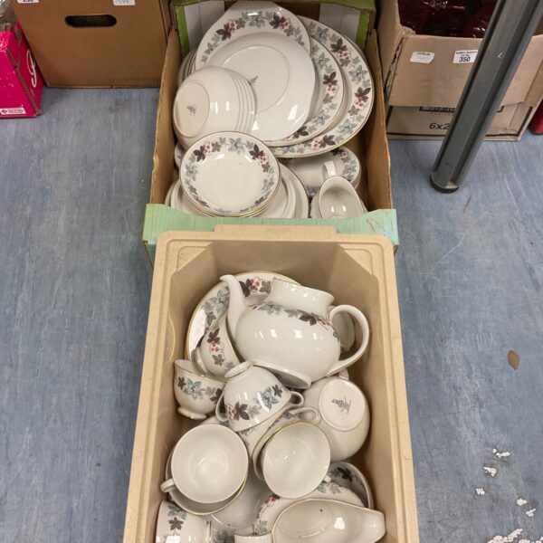 Royal Doulton dinner service with a floral pattern displayed on a table.