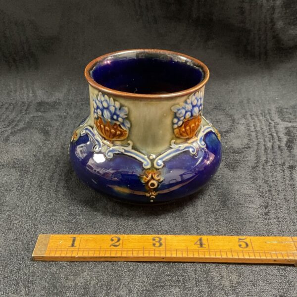 Antique Royal Doulton Lambeth vase with floral design.