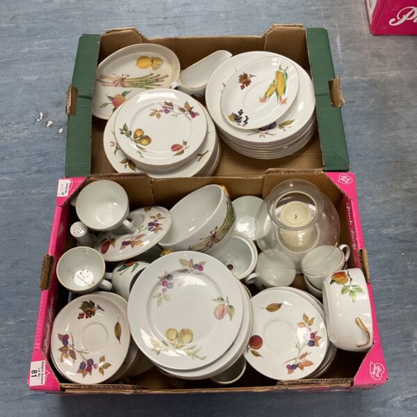 Royal Worcester Evesham pattern china plates stacked in a box.