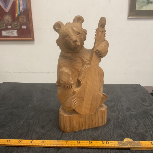 Vintage Russian folk art bear playing a cello, detailed carving.