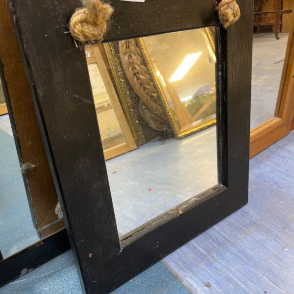 Black wooden framed mirror with rustic rope detail.