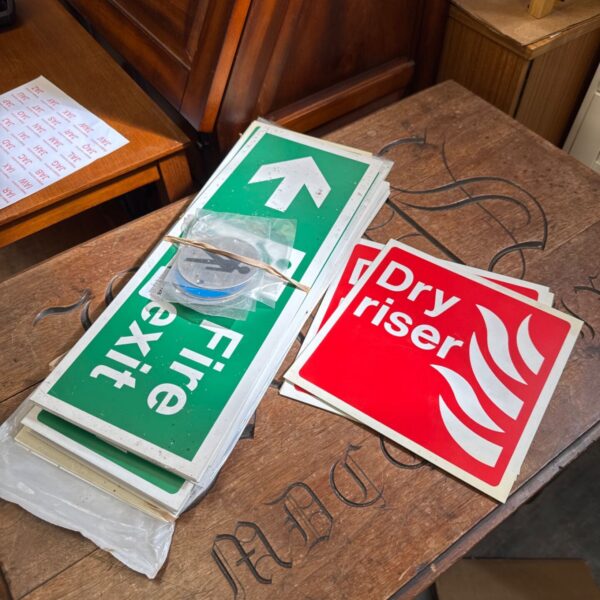 Lot of health and safety signage including directional arrows.