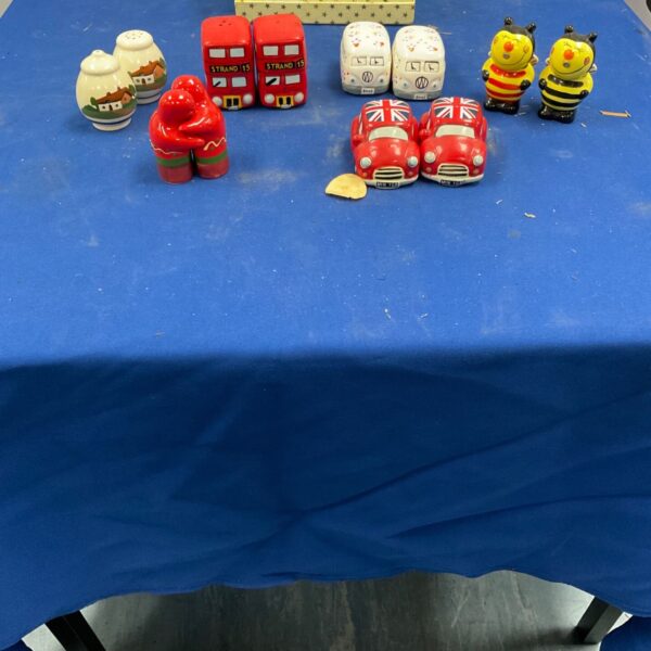 Vintage salt and pepper shakers including London buses and VW camper vans.
