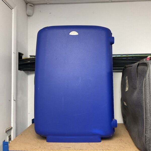 Blue Samsonite hardshell suitcase on a shelf.