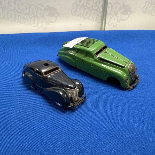 Vintage Schuco tin plate cars, side view.