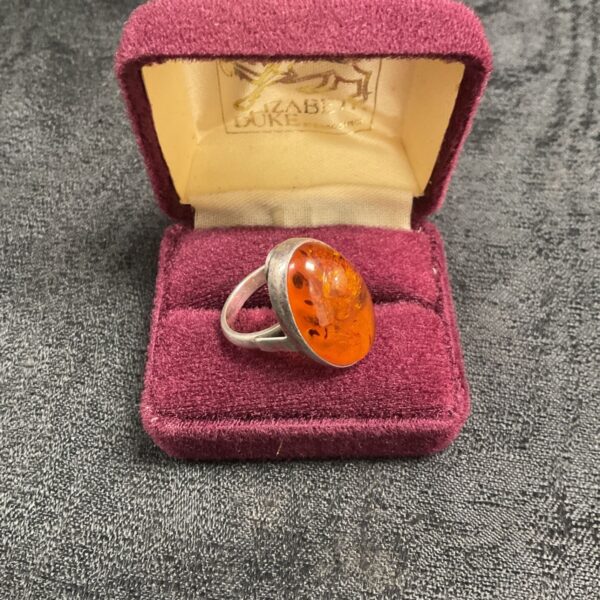 Vintage silver ring with oval amber stone.