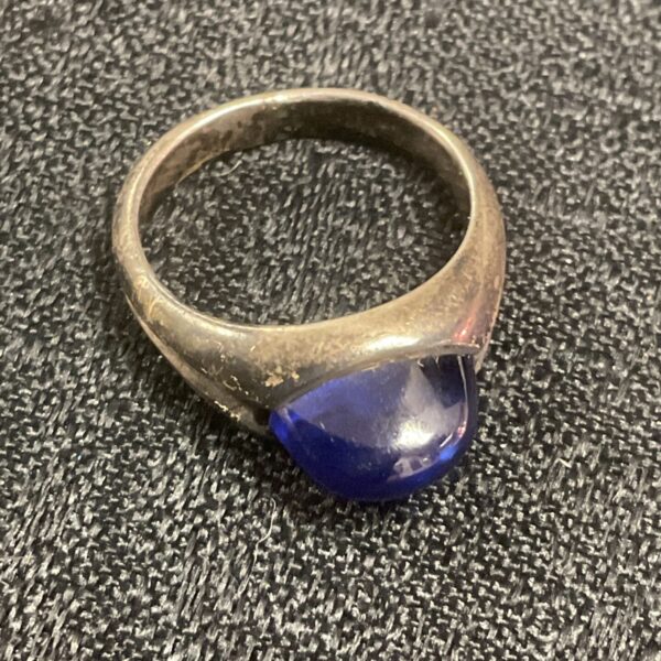 Silver ring with a dark blue stone, size J.