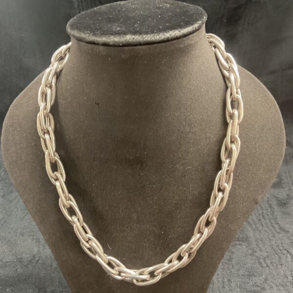 Close-up of a silver chunky chain necklace.