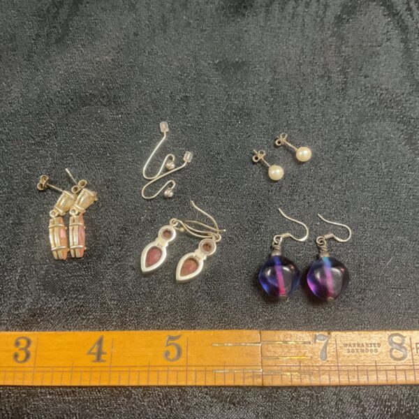 Lot of five pairs of 925 silver earrings with varied designs.