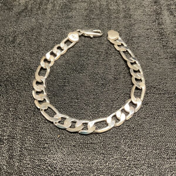 Close-up of a silver Figaro bracelet with a classic link design.
