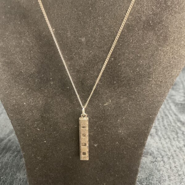 Hallmarked silver lozenge pendant necklace on a chain.