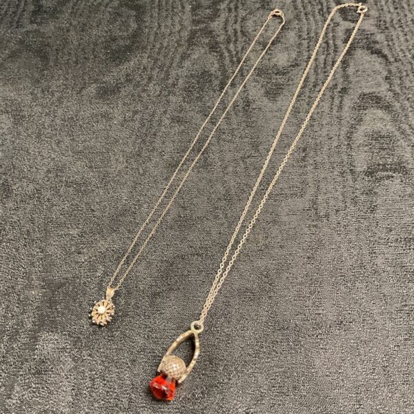 Silver necklace with opal and Scottish thistle pendants.