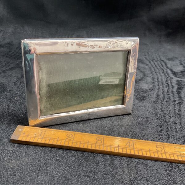 Antique silver photo frame with embossed detail, hallmarked 1911.