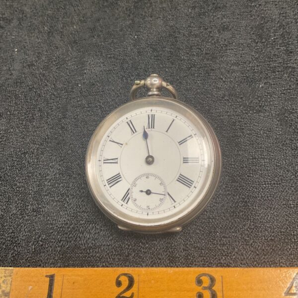 Antique silver pocket watch with Roman numerals.