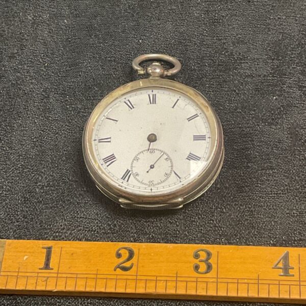 Antique silver pocket watch with Roman numerals, front view.