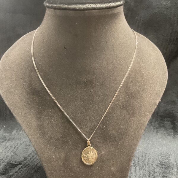 Vintage silver St Christopher pendant necklace with detailed design.
