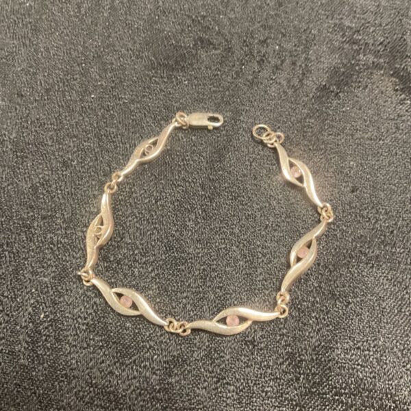 Close-up of a silver wave link bracelet.