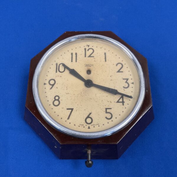 Antique Smiths bakelite wall clock with clear dial.