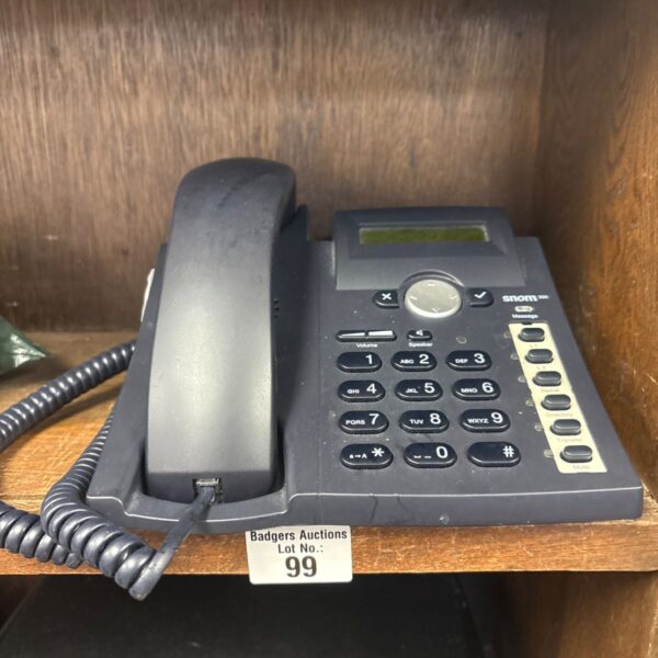 Snom 300 VoIP phone with handset and coiled cord.