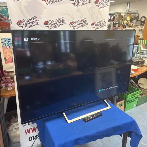 Sony 55 inch television with remote control in a home setting.