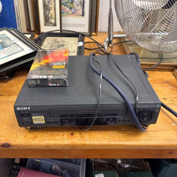 Sony SLV-SE45 VCR recorder with blank tape, vintage electronics.