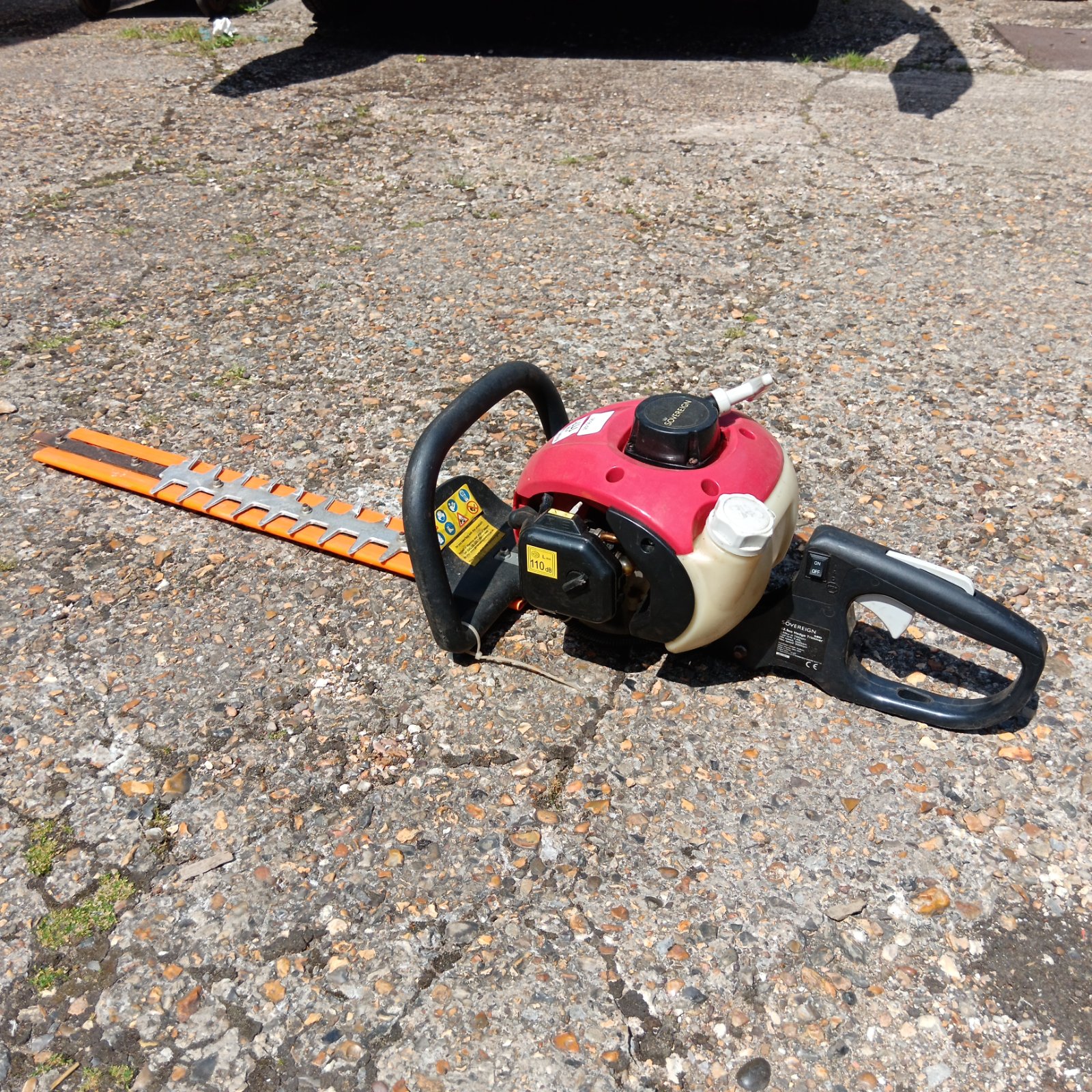 Sovereign petrol hedge cutter with long blade for garden trimming.