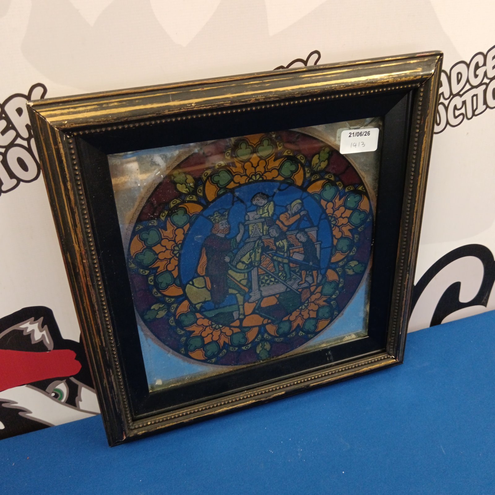 Circular stained glass panel depicting a royal scene with vibrant colours.