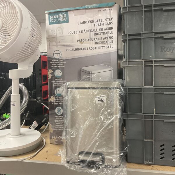 Two stainless steel pedal bins in packaging.