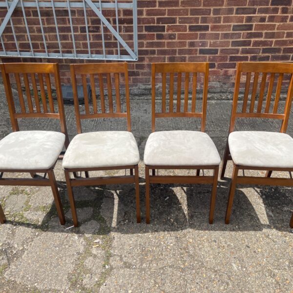 Set of four vintage Stakmore folding chairs with upholstered seats.