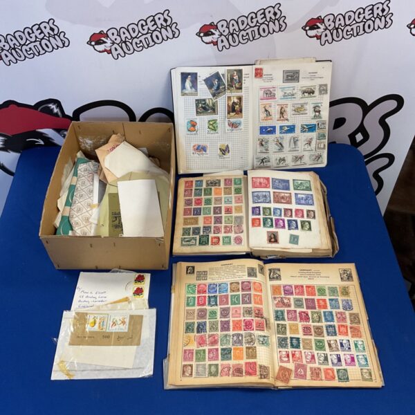 Vintage stamp collection with albums and loose stamps.