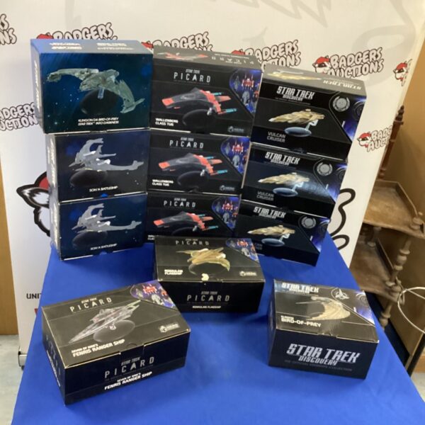 Star Trek collectors models in boxes, vintage sci-fi ships.