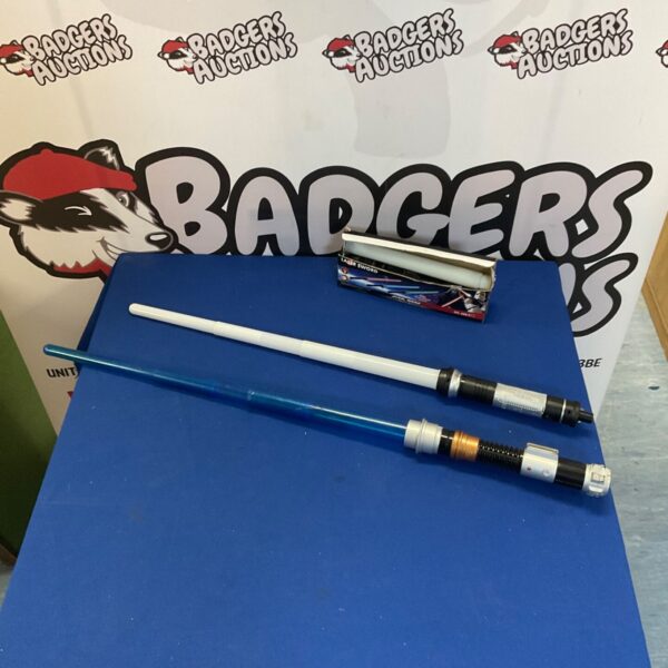 Lot of three Star Wars toy lightsabers for collectors.