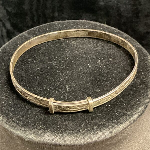 Delicate sterling silver christening bracelet with engraved details.