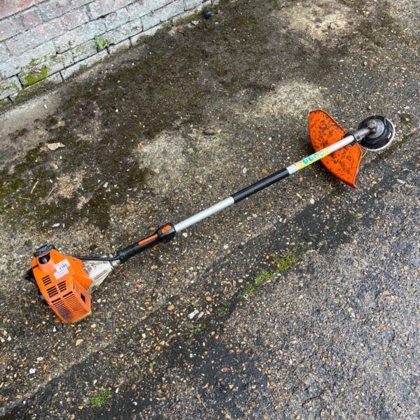 Stihl brushcutter with loop handle and protective guard.