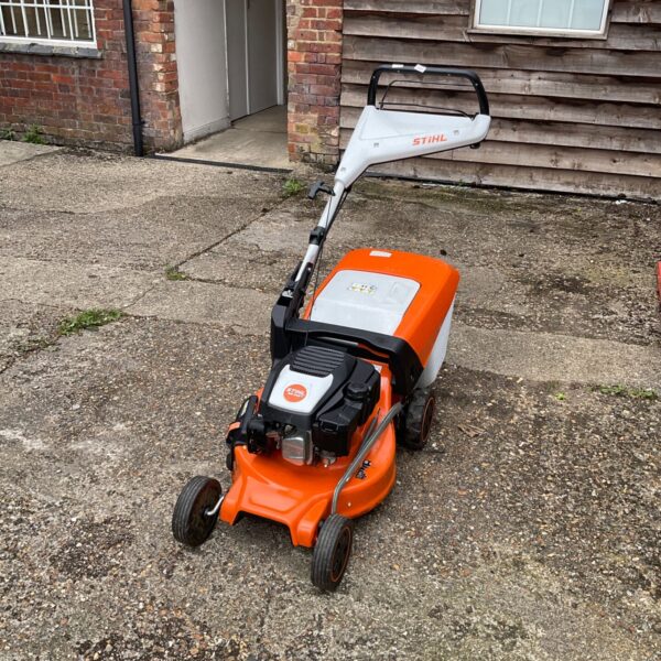 Stihl RM 248 T petrol lawnmower in a garden setting.