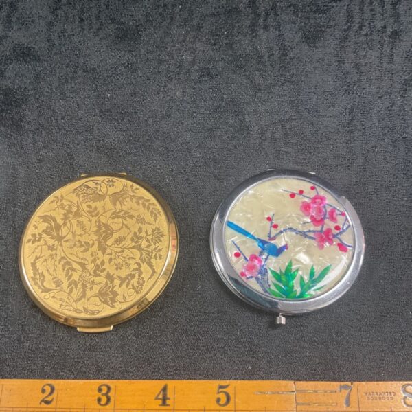 Vintage Stratton compact mirror with bird and floral decoration.