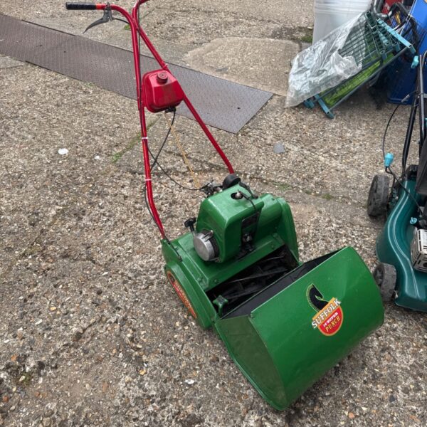Vintage Suffolk Super Punch lawnmower in green with red fuel tank.