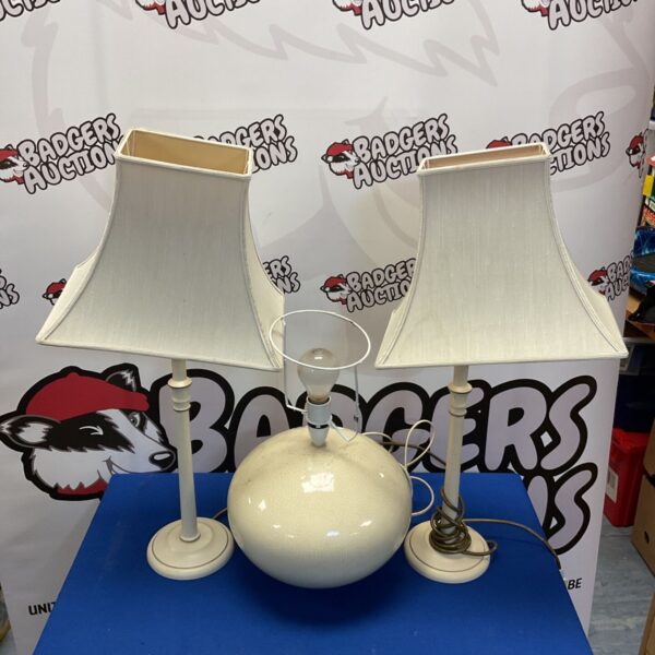 Vintage table lamps with globe shades and metallic stems.