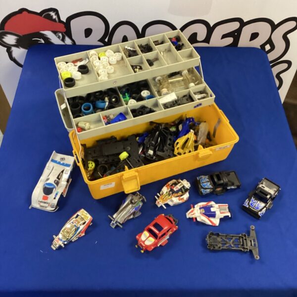 Tamiya slot car parts lot in a plastic storage box.