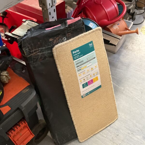 Lot of nine new Tapi Porto coir door mats stacked together.