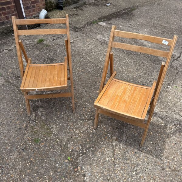 Vintage teak folding garden chairs, a classic pair for outdoor use.