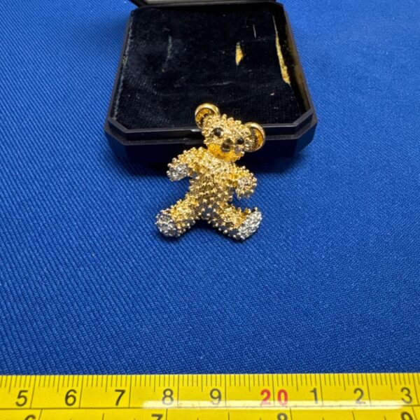 Vintage gold and diamanté teddy bear brooch in case.